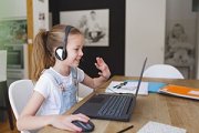 Junges Mädchen vor Laptop während Fernunterricht 