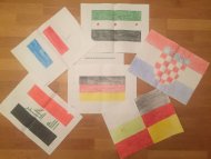 Sechs verschiedene gemalte Nationalflaggen, die die alte Heimat und die neue Heimat Deutschland darstellen sollen