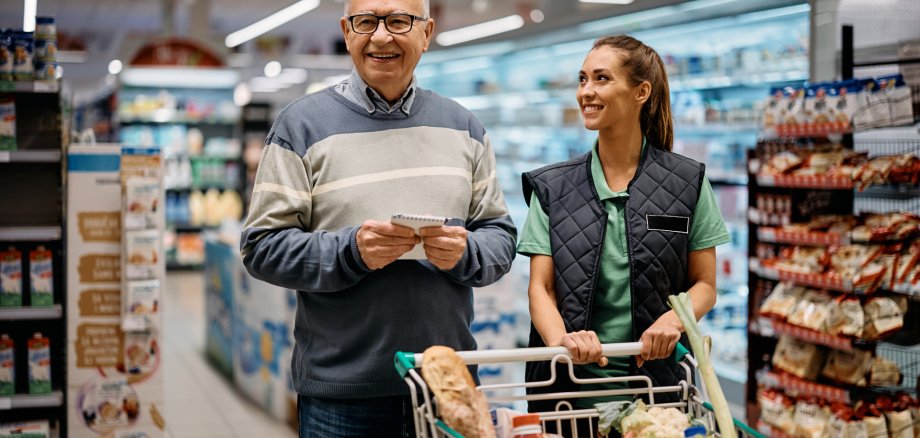 Happy senior buyer and supermarket worker at the store. Happy senior buyer and supermarket worker at the store.