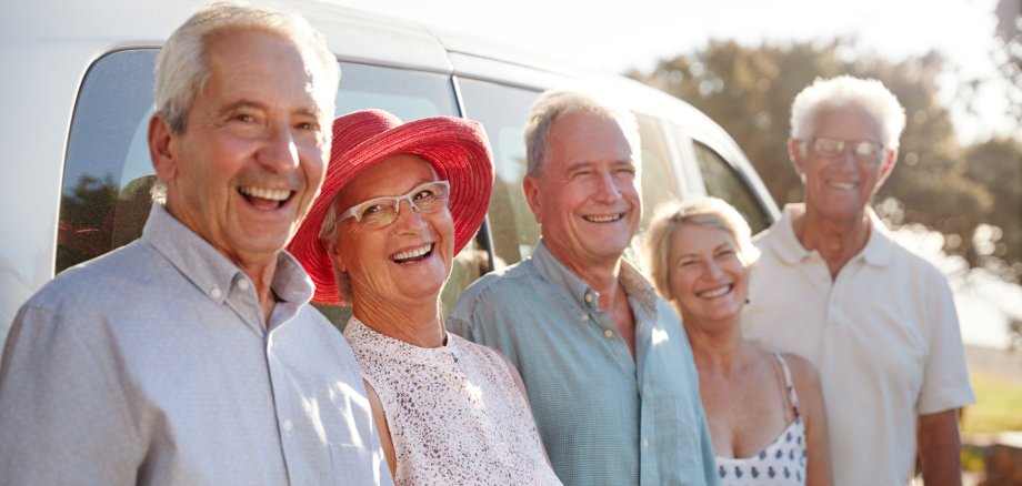 Portrait Of Senior Friends Standing Together Beside Van On Vacation Portrait Of Senior Friends Standing Together Beside Van On Vacation