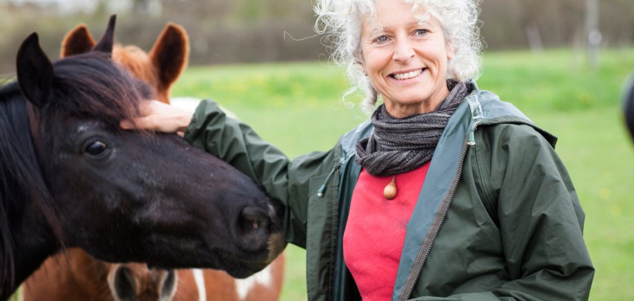 Woman stroking horse